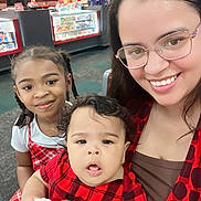 Michael Neil Adames joined the competition — help win amazing prizes! woman, child, toddler, glasses, smile, braids, red_plaid, indoor, store, candy, counter, ladder, person, portrait, happy, family, fashion, clothing, shopping, casual