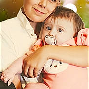 Layla-Rose is registered to the contest to win money with this photo: child, baby, pacifier, hug, smile, portrait, family, love, tenderness, warmth, closeup, candid, cute, infant, holding, pink_clothing, happy, sibling, indoor, soft_light