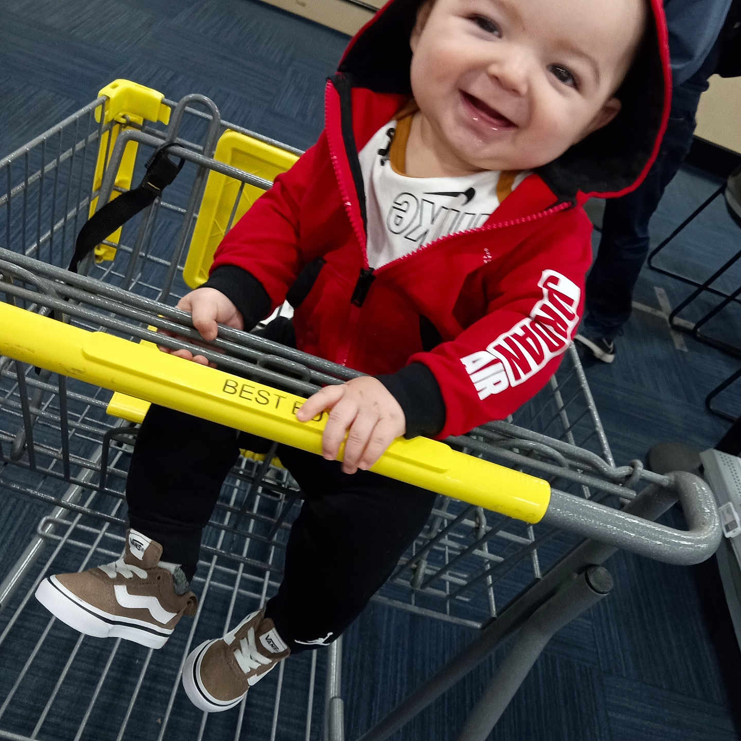 Rocky is registered to the contest to win money with this photo: baby, boy, child, clothing, coat, face, footwear, hat, head, hood, jacket, machine, male, pants, person, photography, portrait, shoe, shoppingcart, wheel