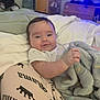 Preston joined the competition — help win amazing prizes! baby, blanket, bed, smile, infant, clothing, person, soft, indoor, furniture, fabric, cute, comfort, child, portrait, relaxing, young, sleepwear, cushion, home