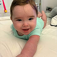 Preston is registered to the contest to win money with this photo: arm, baby, bed, child, clothing, cute, expression, face, hand, happy, head, indoor, infant, lying_down, person, portrait, reaching, skin, smiling, young