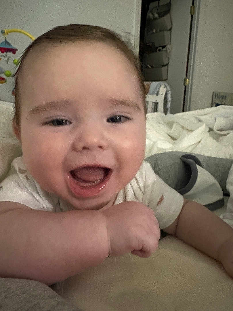 Preston is registered to the contest to win money with this photo: baby, smiling, face, infant, arm, indoor, blanket, toy, happy, child, person, closeup, expression, skin, mouth, furniture, head, couch, home, toddler