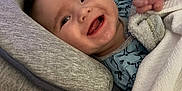 Preston is registered to the contest to win money with this photo: baby, smiling, blanket, cushion, bed, crib, clothing, happy, face, infant, indoors, person, sleepwear, cute, child, comfort, resting, portrait, young, cozy