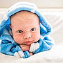 baby, blue_hood, blanket, child, cute, face, fluffy, hood, infant, indoors, looking_down, portrait, resting, soft_texture, white_background, young_child, cozy, hands, expression, closeup