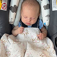 Skyler is registered to the contest to win money with this photo: baby, blanket, car_seat, child, closeup, clothing, comfort, cushion, cute, face, hands, headrest, indoors, infant, nap, pattern, peaceful, resting, sleeping, soft