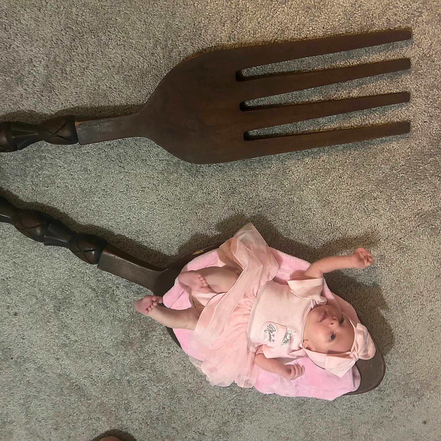 Skyler is registered to the contest to win money with this photo: adorable, baby, baby_girl, blanket, carpet, child, curious, cute, decorative, floor, headband, human, indoors, infant, lying_down, pink_clothing, small, soft_texture, tiny, wooden_fork