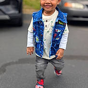 Princeton joined the competition — help win amazing prizes! toddler, child, smiling, denim_vest, shirt, palm_tree_pattern, gray_pants, sneakers, outdoor, asphalt, car, blurred_background, walking, happy, casual_clothing, person, cute, young_child, daylight, urban