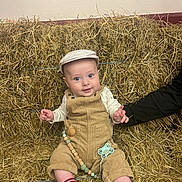 Gabriel a rejoint le concours — aidez-le/la à gagner de superbes lots ! baby, cap, child, comfort, corduroy, cute, expression, face, hand, hay, indoor, infant, overalls, pacifier, person, rustic, sitting, smiling, socks, support