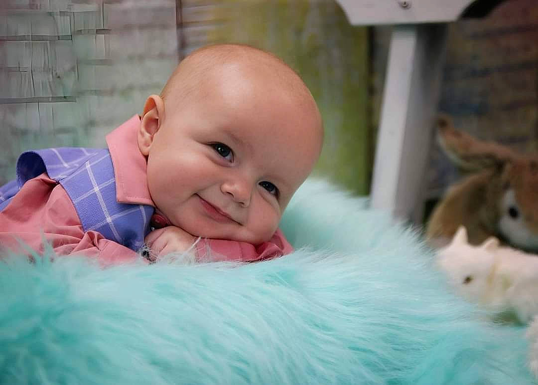 Bellamy is registered to the contest to win money with this photo: baby, baby_products, baby_toddler_clothing, child, comfort, companion_dog, eye, flash_photography, fun, fur, grass, happy, iris, joy, laugh, linens, person, portrait_photography, room, sitting