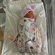 Evelynn joined the competition — help win amazing prizes! newborn, baby, sleeping, infant, hospital, bassinet, swaddled, blanket, floral, hat, bow, pacifier, portrait, nursery, birth,  안전, face, indoors, medical, resting