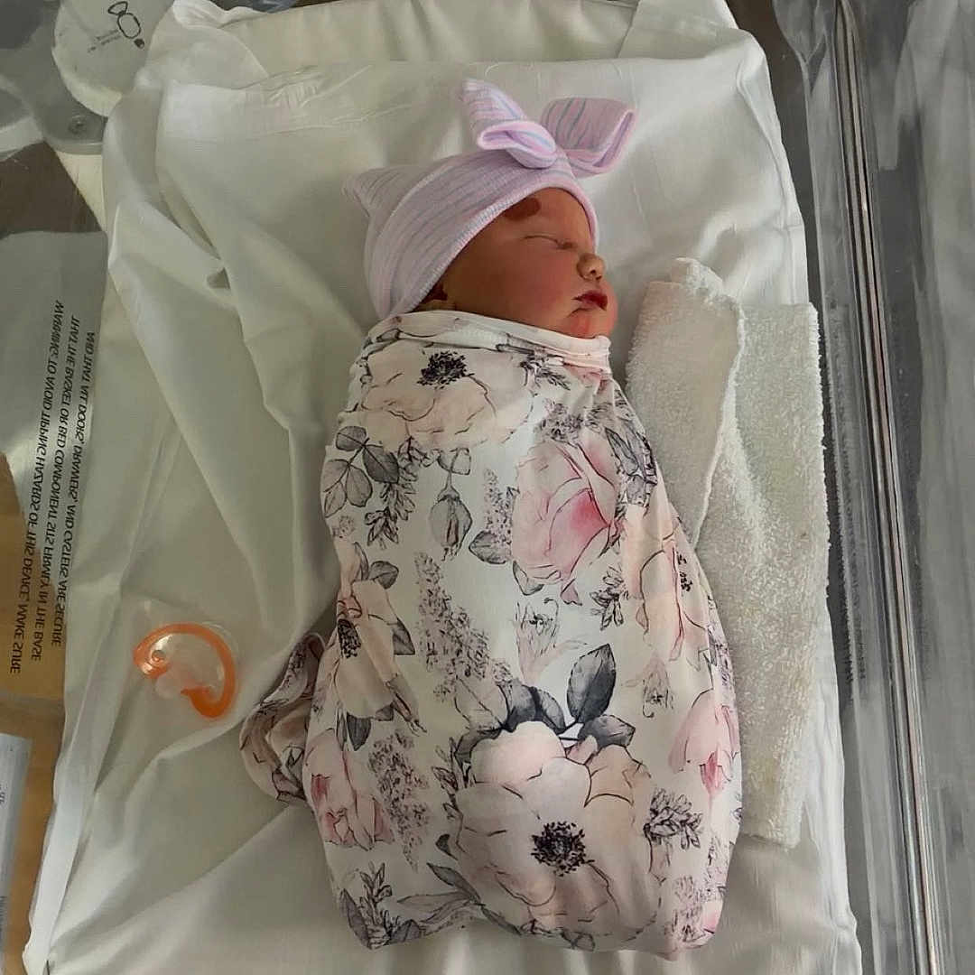 Evelynn joined the competition — help win amazing prizes! newborn, baby, sleeping, infant, hospital, bassinet, swaddled, blanket, floral, hat, bow, pacifier, portrait, nursery, birth,  안전, face, indoors, medical, resting