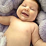 Charli is registered to the contest to win money with this photo: baby, smiling, blanket, soft, fluffy, cheeks, skin, happy, infant, lying_down, comfort, cute, child, portrait, closeup, warm, relaxed, cozy, sleepy, toddler