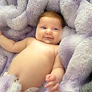 Charli is registered to the contest to win money with this photo: baby, infant, smile, blanket, soft, fluffy, cozy, diaper, skin, cute, lying_down, child, comfort, relaxation, indoors, portrait, baby_skin, happy, small_hand, young