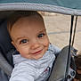 baby, infant, child, stroller, stroller_canopy, canopy, seat, harness, smile, eyes, hand, hood, jacket, portrait, happy, outdoor, pavement, playful, closeup, baby_clothing