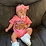 Karmyn is registered to the contest to win money with this photo: baby, infant, girl, pink_onesie, headband, bow, pacifier, white_sneakers, couch, gray_couch, seated, cute, child, indoor, portrait, clothing, footwear, baby_fashion, young_child, comfortable