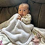 baby, blanket, couch, pacifier, infant, face, hand, clothing, fabric, soft, comfort, seated, indoors, cute, child, person, portrait, rest, warm, expression