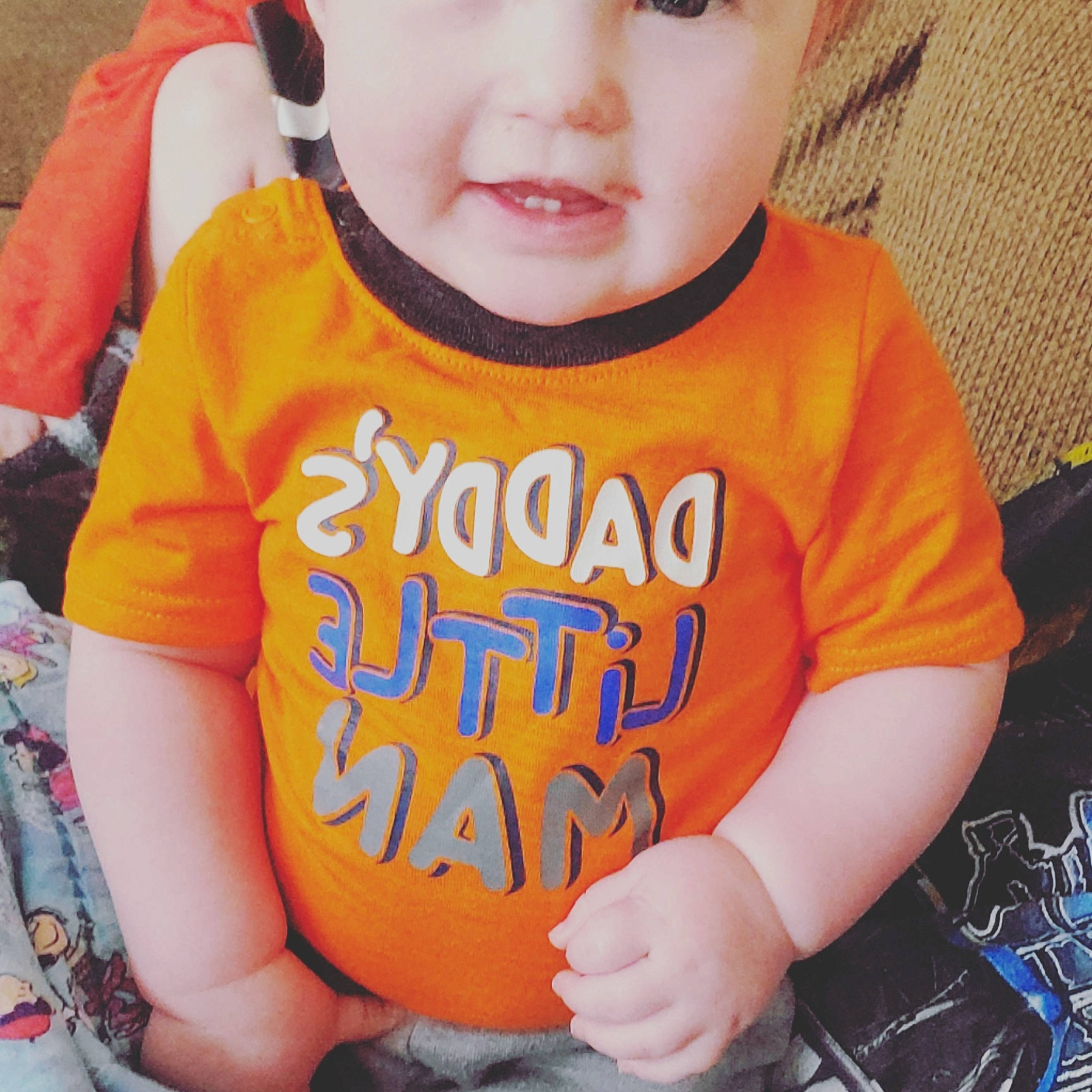 Hunter is registered to the contest to win money with this photo: baby, baby_toddler_clothing, candy_corn, cheek, child, cool, ear, happy, lip, orange, person, plant, play, product, sleeve, smile, t_shirt, toddler, top, yellow