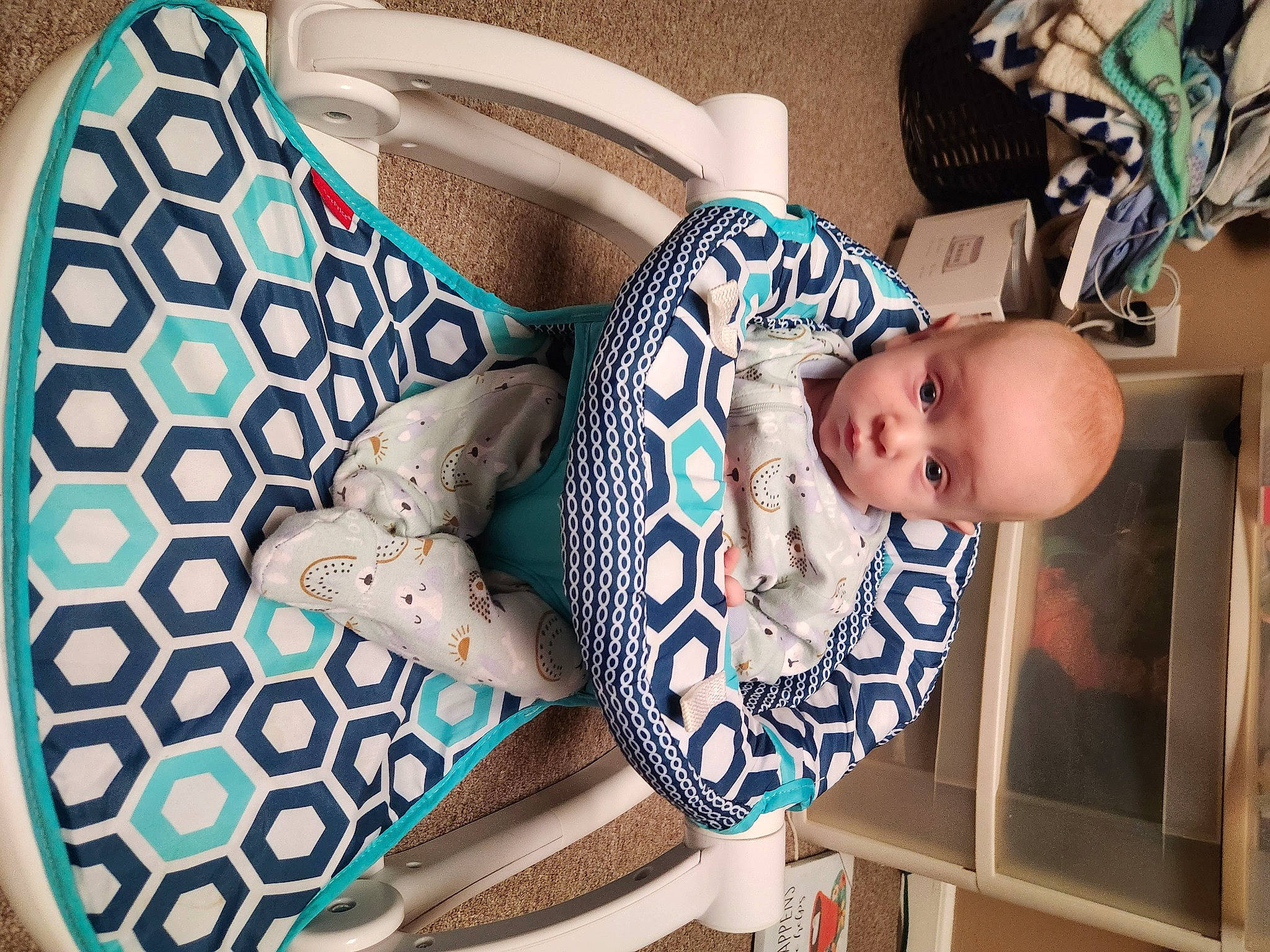 Charles is registered to the contest to win money with this photo: baby, baby_products, baby_safety, baby_toddler_clothing, bag, child, circle, comfort, electric_blue, fashion_accessory, linens, pattern, person, product, room, rose, sitting, sleeve, textile, toddler