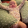 Stella joined the competition — help win amazing prizes! baby, infant, smile, arms_raised, cushion, pillow, onesie, floral_pattern, bed, comfort, indoor, happy, child, person, cute, resting, soft_furniture, skin, head, legs