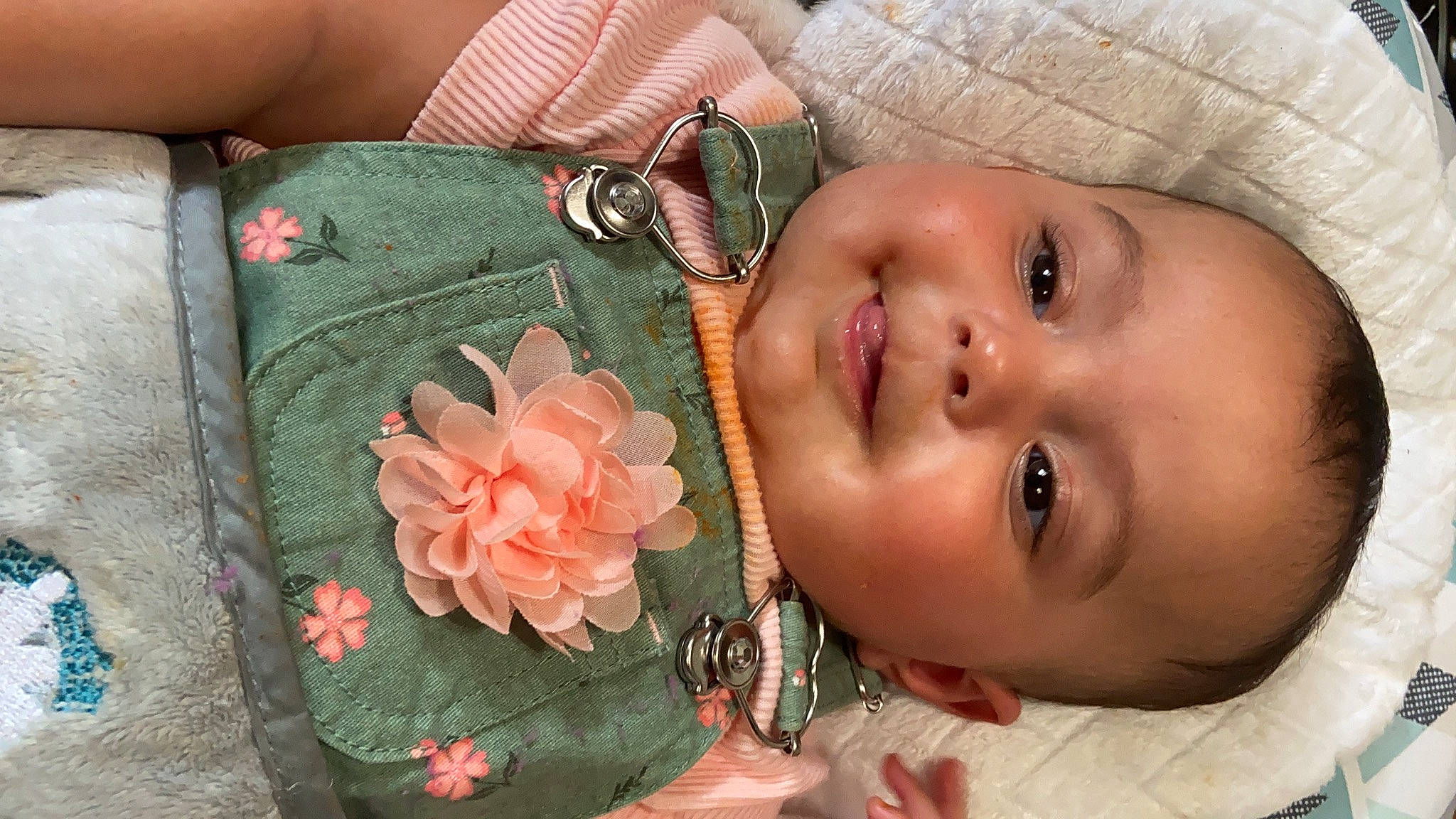 Madelyn is registered to the contest to win money with this photo: baby, eye, eyebrow, eyelash, finger, flower, green, hand, happy, hat, headgear, iris, joy, leaf, lip, mouth, neck, person, petal, plant