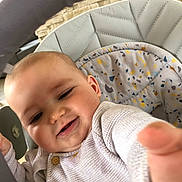 Livio participe au concours pour gagner de l'argent avec cette photo : baby, child, smiling, high_chair, indoor, face, person, clothing, sweater, hand, cute, happy, infant, seat, patterned_cushion, skin, head, expression, baby_furniture, closeup