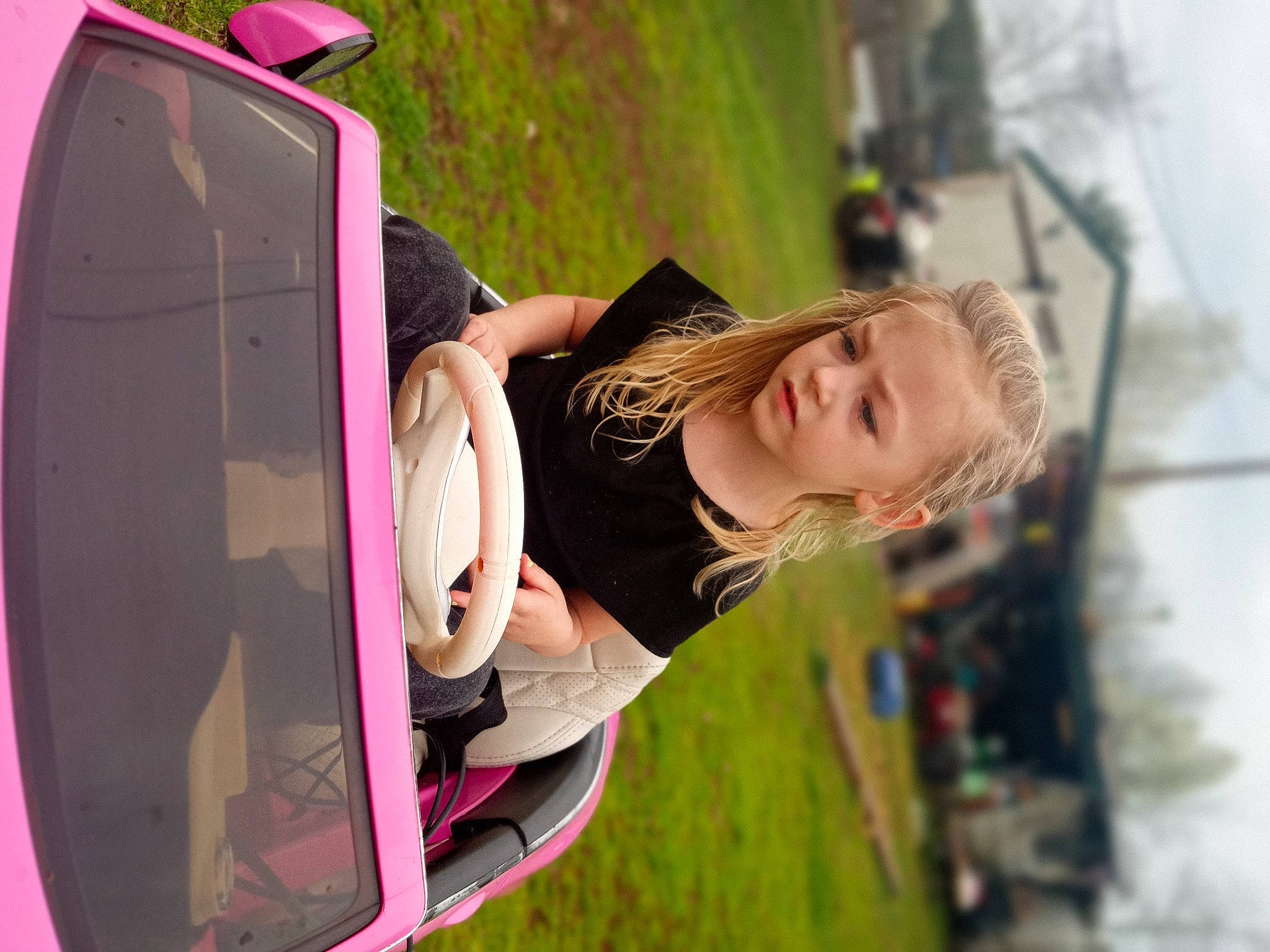 Ansley is registered to the contest to win money with this photo: automotive_design, automotive_exterior, automotive_lighting, bumper, car, child, cool, daytime, fun, grass, happy, leisure, motor_vehicle, person, plant, summer, tints_and_shades, tree, trunk, vehicle