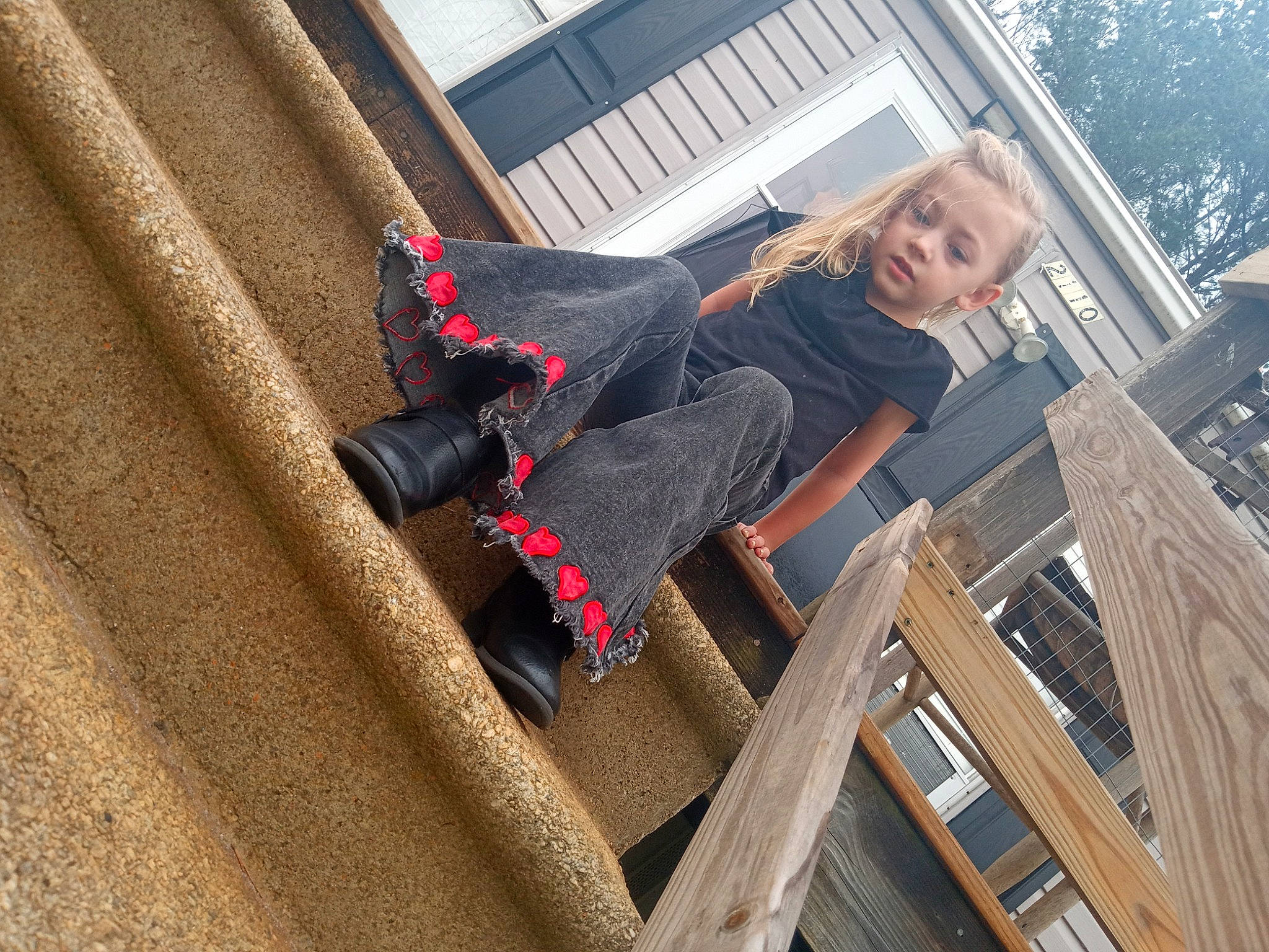 Ansley is registered to the contest to win money with this photo: building, daylighting, denim, facade, fun, house, human_leg, knee, leg, leisure, pattern, person, roof, sitting, thigh, tree, waist, window, wood