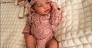 Sienna is registered to the contest to win money with this photo: baby, bed, blanket, bow, child, face, feet, headband, indoors, infant, lace, lying_down, newborn, photography, pink_outfit, plush_toy, portrait, quilt, sleeping_area, stuffed_animal