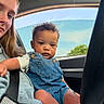 Grayson is registered to the contest to win money with this photo: baby, backseat, blonde_hair, car, car_interior, casual_clothing, child, curly_hair, daylight, denim_overalls, family, infant, outdoor_view, photograph, portrait, road_trip, sitting, sky, toddler, travel