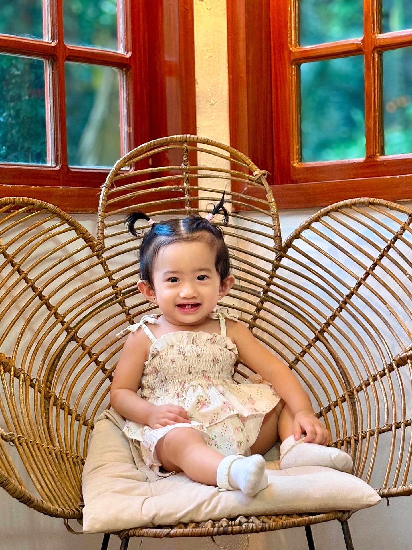 Sophia Hope Louise joined the competition — help win amazing prizes! toddler, child, smiling, sitting, wicker_chair, heart_shaped_chair, pigtails, indoors, window, wooden_frame, cushion, white_socks, dress, happy, cute, furniture, portrait, person, baby, home