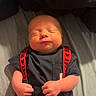 baby, newborn, infant, sleeping, clothing, suspenders, mickey_mouse, red, black, hands, face, portrait, cute, child, person, indoors, bed, blanket, soft_light, resting
