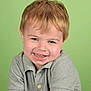 child, smile, portrait, blond_hair, blue_eyes, polo_shirt, green_background, happy, casual_clothing, cute, toddler, face, person, young_child, studio_photo, short_sleeves, light_skin, button, indoors, head_and_shoulders