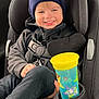 child, toddler, car_seat, hat, smile, toy_story, sippy_cup, jacket, seatbelt, car_interior, happy, blue_eyes, clothing, young_child, portrait, casual, kid, seat, cozy, travel