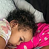 Summer is registered to the contest to win money with this photo: toddler, child, pacifier, curly_hair, blanket, polka_dots, pillow, close_up, sleepy, resting, infant, cute, indoors, soft_texture, pink, white, skin, face, hand, clothing