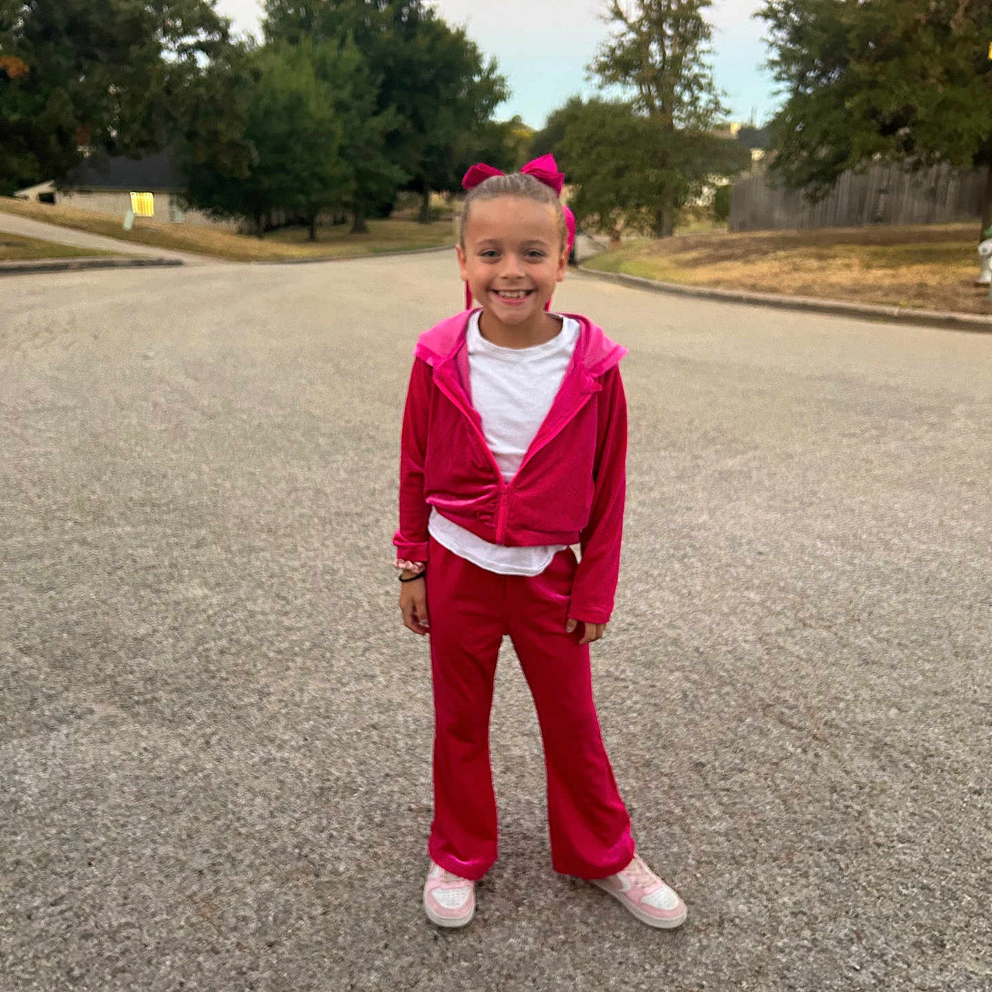Rikki is registered to the contest to win money with this photo: child, clothing, face, female, footwear, formalwear, girl, head, longsleeve, pants, person, photography, plant, portrait, road, shoe, sleeve, standing, tree, walking