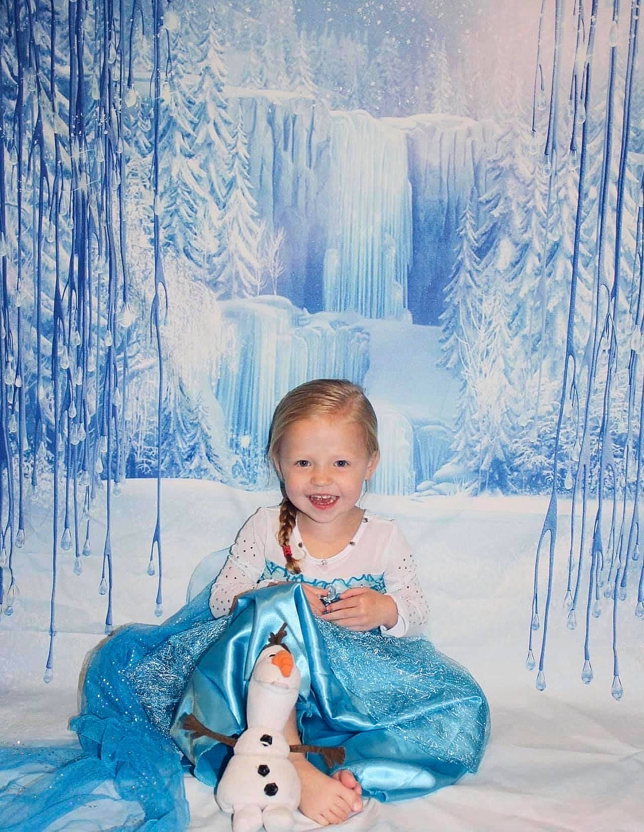 Amelia is registered to the contest to win money with this photo: baby_toddler_clothing, beauty, blue, child, dress, electric_blue, forest, freezing, fun, happy, joy, leisure, people_in_nature, person, photograph, sitting, snow, toddler, toy, tree