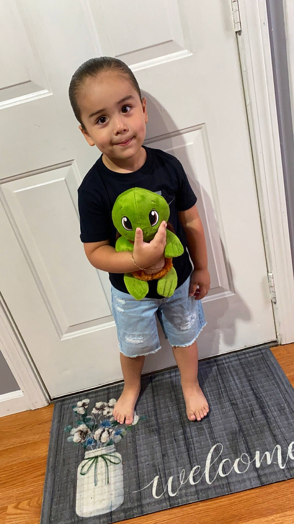 Elvin is registered to the contest to win money with this photo: baby, baby_toddler_clothing, chest, child, elbow, face, flooring, fun, happy, head, joy, person, room, shorts, shoulder, sleeve, standing, stuffed_toy, t_shirt, toddler