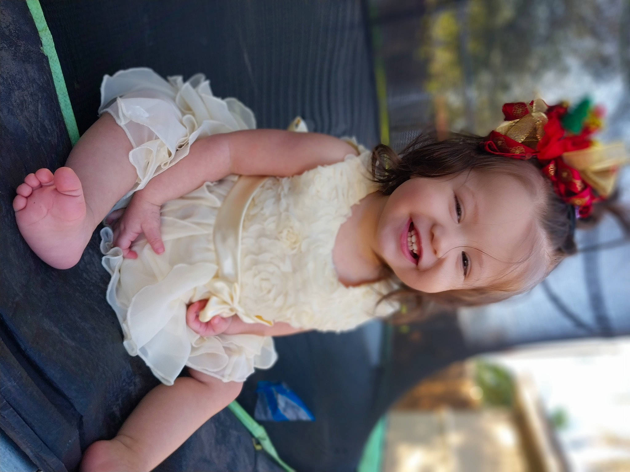 Genesis is registered to the contest to win money with this photo: baby, baby_toddler_clothing, child, dress, event, fun, grass, hand, happy, headpiece, iris, joy, person, pink, plant, portrait_photography, sitting, skin, smile, toddler