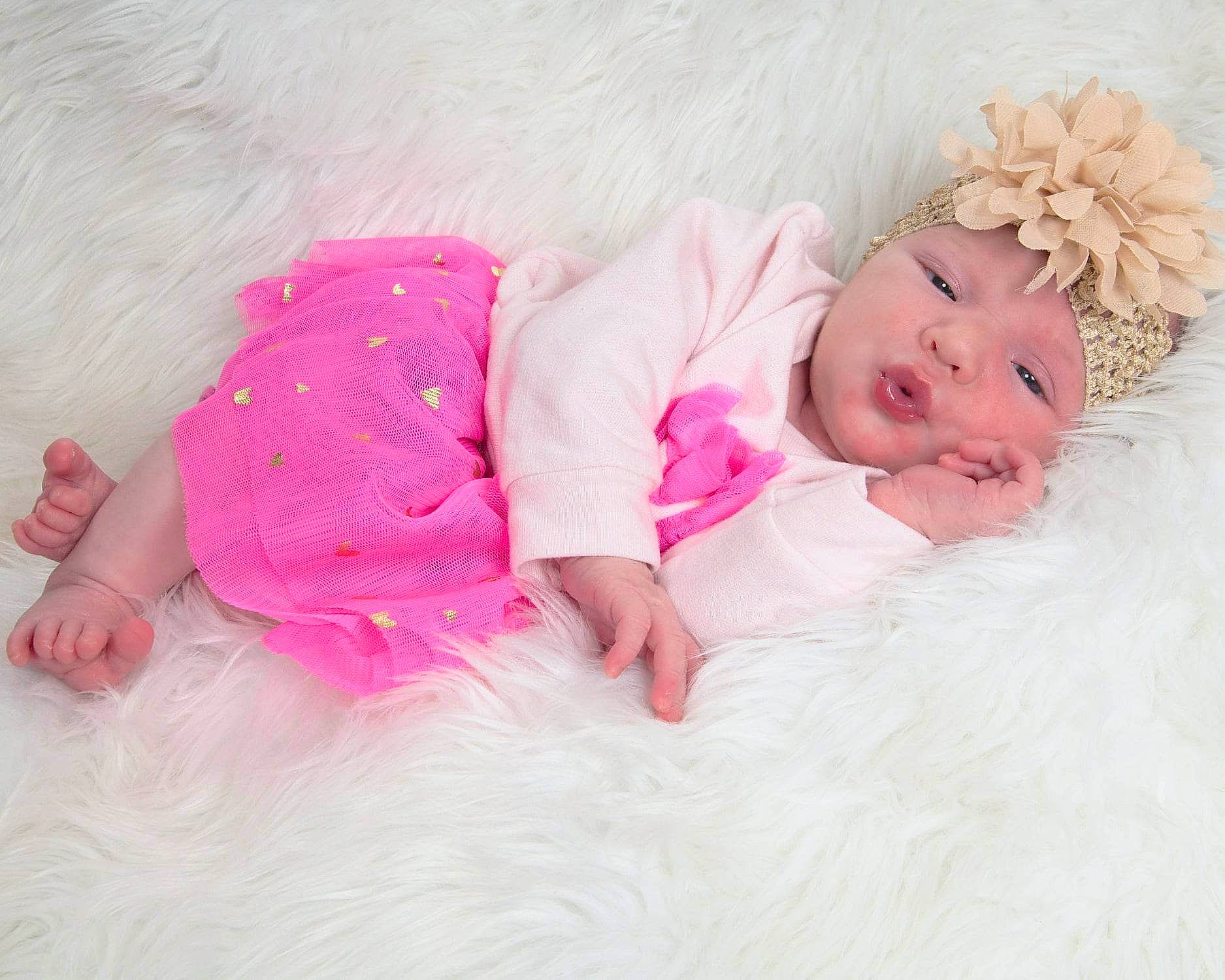 Madelynn joined the competition — help win amazing prizes! baby, baby_toddler_clothing, child, comfort, embellishment, eye, flooring, fur, grass, happy, head, headgear, headwear, linens, magenta, person, petal, pink, skin, sleeve