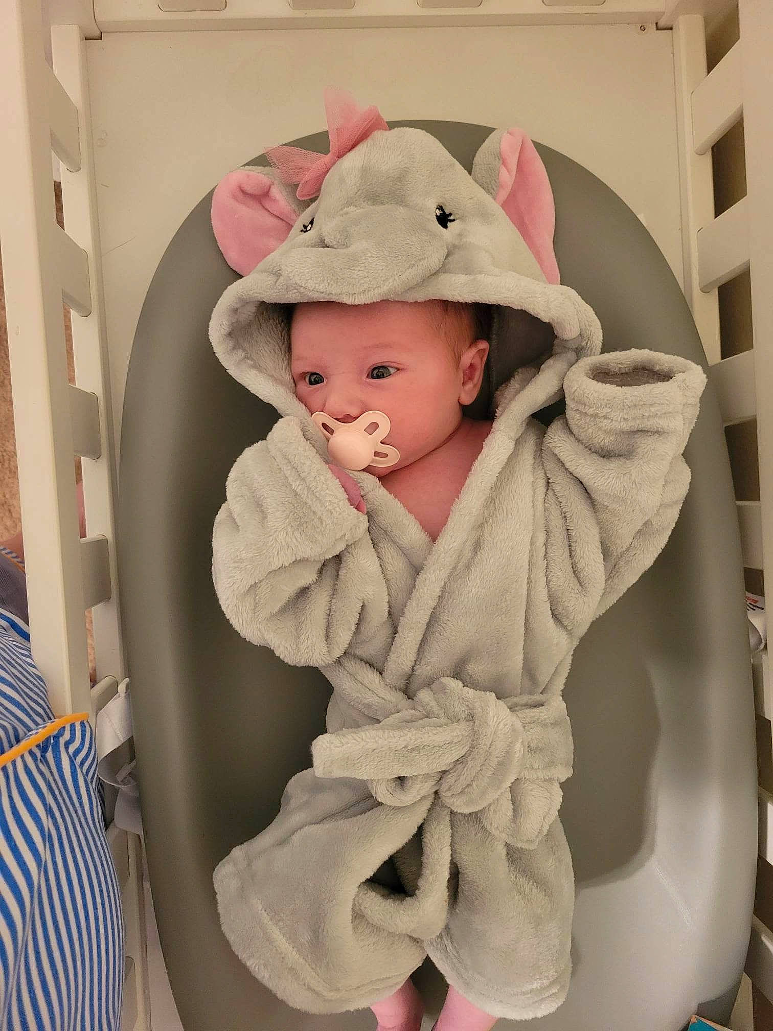 Madelynn joined the competition — help win amazing prizes! baby, baby_carriage, baby_products, baby_safety, baby_sleeping, baby_toddler_clothing, cap, cheek, child, comfort, face, fashion_accessory, hair_accessory, headwear, linens, pattern, person, pink, sitting, sleeve