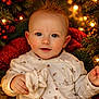 baby, infant, child, christmas, holiday, twinkle_lights, bokeh, pine_branch, red_berries, cozy_blanket, onesie, portrait, blue_eyes, rosy_cheeks, hands, smile, soft_lighting, festive, indoor, close_up