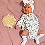 Piper joined the competition — help win amazing prizes! baby, blanket, child, cute, decor, floral_pattern, happy, headband, indoors, infant, lying_down, milestone, newborn, one_month, pink_blanket, portrait, smiling, socks, white_clothing, wooden_plaque
