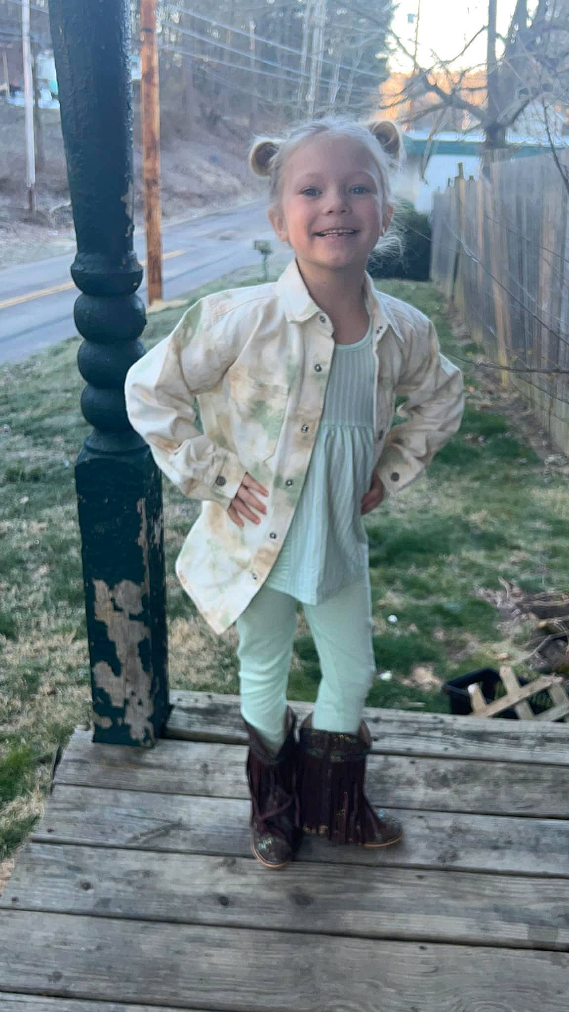 Paisley joined the competition — help win amazing prizes! baby_toddler_clothing, boot, child, eye, face, fence, fun, grass, happy, hat, head, human_leg, joy, knee, leisure, pattern, person, sitting, sleeve, smile