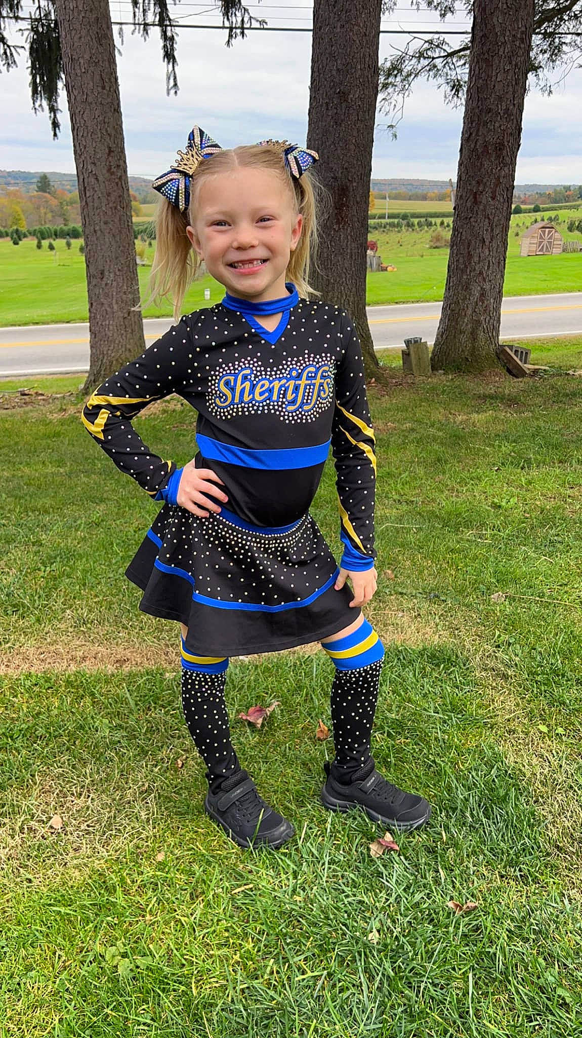 Paisley is registered to the contest to win money with this photo: baby_toddler_clothing, electric_blue, eye, face, fashion_accessory, grass, grassland, happy, human_leg, joy, knee, pattern, people_in_nature, person, personal_protective_equipment, recreation, sky, sleeve, smile, thigh