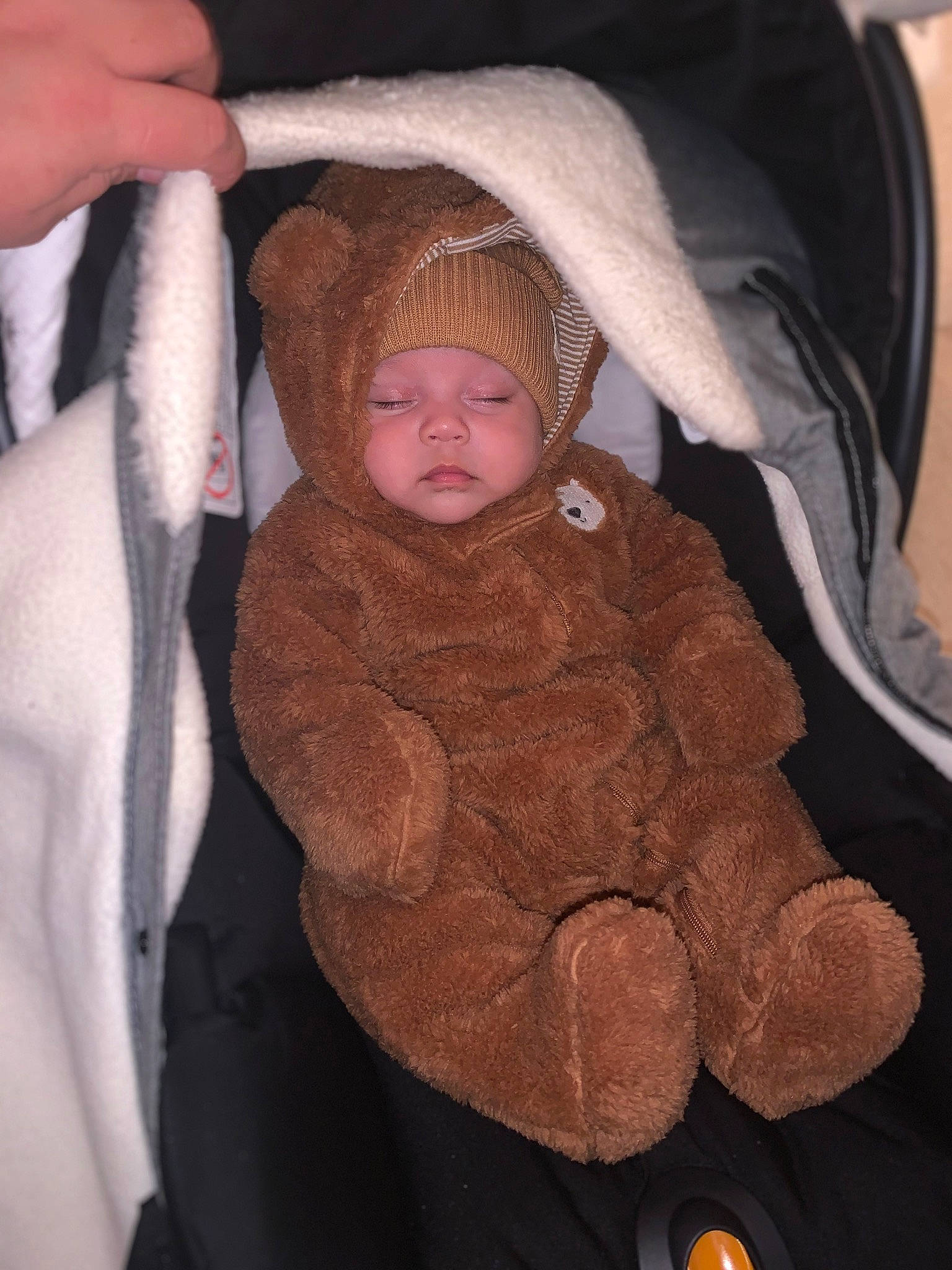Ivan is registered to the contest to win money with this photo: baby, baby_carriage, baby_products, baby_toddler_clothing, cheek, child, comfort, eye, fur, head, headwear, iris, lap, person, personal_protective_equipment, sitting, skin, sleeve, thumb, toddler
