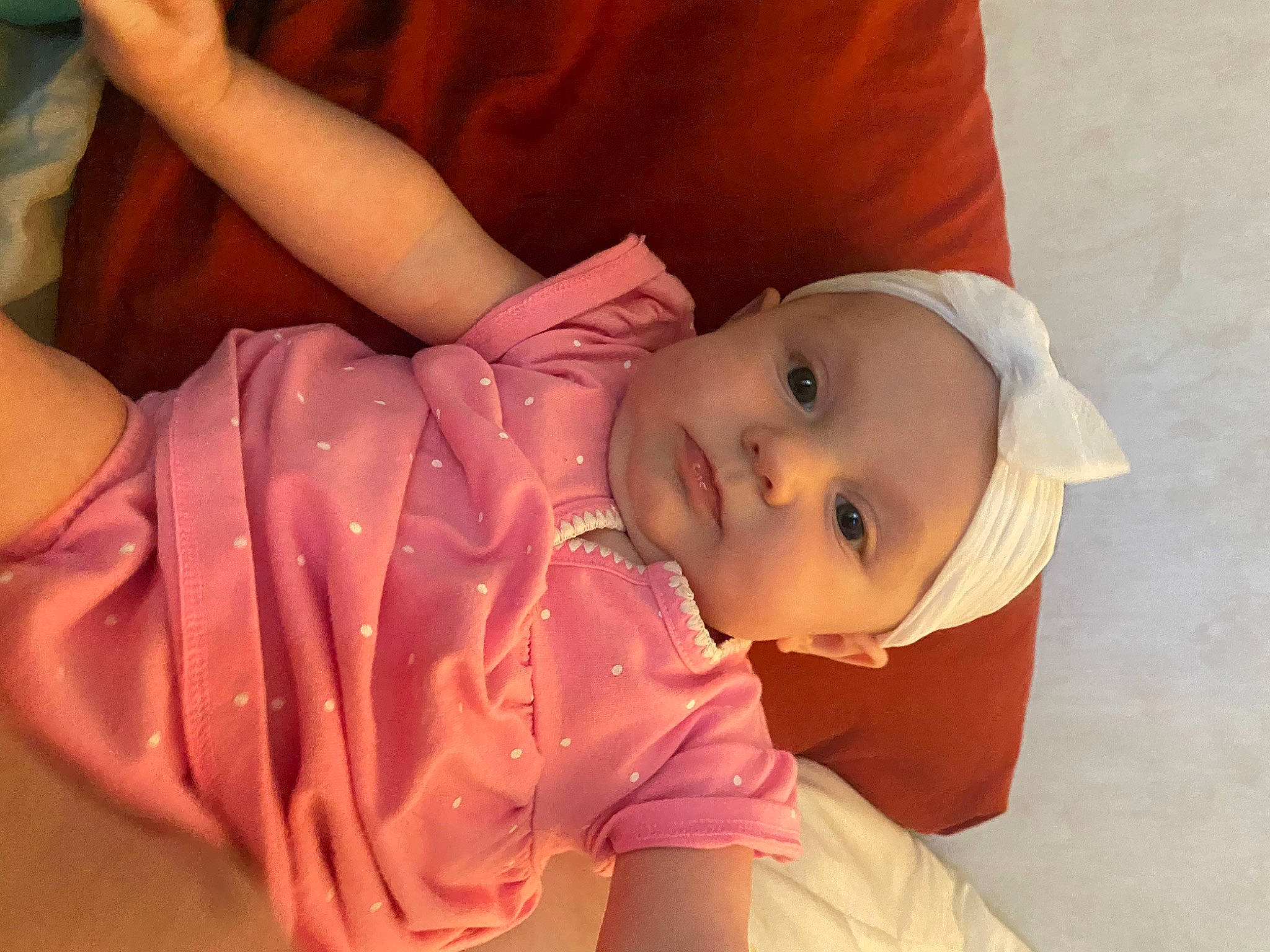 Magnolia is registered to the contest to win money with this photo: baby, baby_toddler_clothing, cheek, eye, eyebrow, eyelash, face, finger, hat, head, headwear, human_body, lip, mouth, neck, nose, orange, person, pink, skin