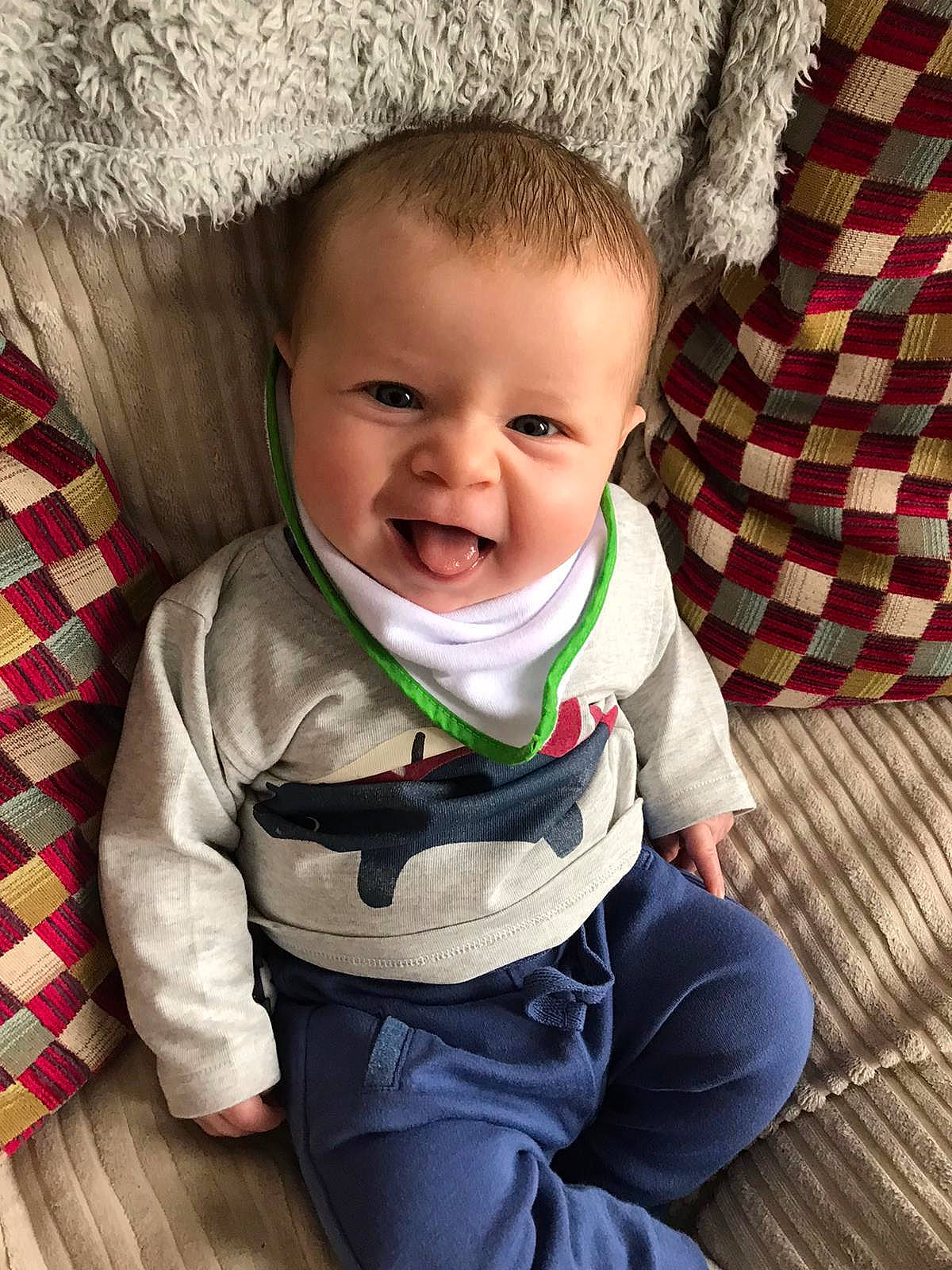 Dougie is registered to the contest to win money with this photo: baby, cheek, child, cool, face, facial_expression, happy, head, headgear, outerwear, people, person, photography, play, sitting, skin, sleeve, smile, toddler