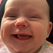 Isla-Rose is registered to the contest to win money with this photo: baby, cheeks, child, closeup, clothing, cute, expression, eyes, face, floral_pattern, happiness, head, indoors, infant, joy, mouth, nose, person, skin, smiling