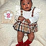 baby, infant, plaid_skirt, white_top, red_bow, headband, red_socks, bows, wooden_sign, number_two, month, blanket, soft_texture, cute, lying_down, wide_eyes, curious, child, portrait, adorable