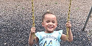 Ce'Ona joined the competition — help win amazing prizes! casual_clothing, child, daytime, fun, grass, happy, nature, outdoor, park, person, playground, recreation, shirt, shorts, smiling, summer, swing, tree, wood_chips, yellow_chains